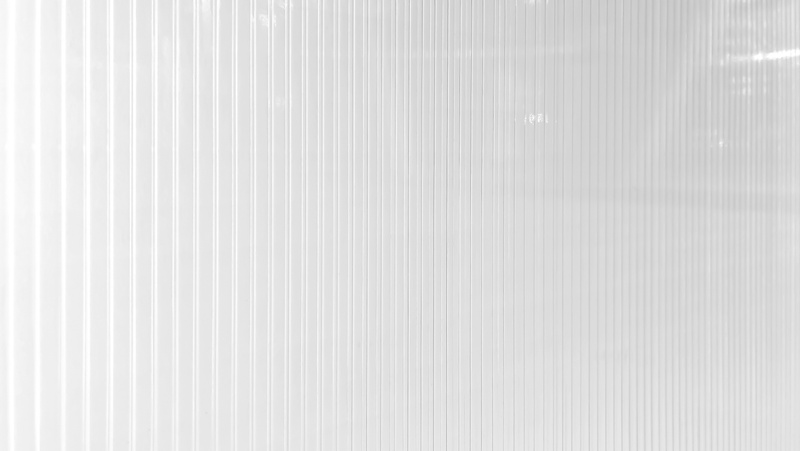 white polycarbonate in perspective view use as background, banner or wallpaper. polycarbonate plastic texture. transparent material corrugated plastic surface use for partition wall or roofing.